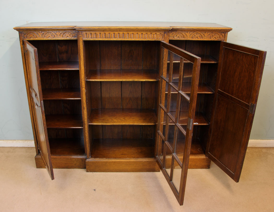 11377r10 Antique Oak Cabinet Bookcase, Antique Breakfront Oak Cabinet Bookcase. This quality oak breakfront bookcase cabinet has a solid oak top with moulded edge under having carved detail
